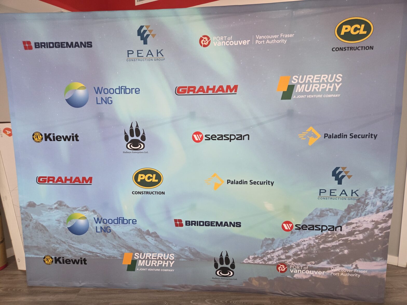Tension fabric media walls Vancouver displaying sponsor logos for a local corporate event.