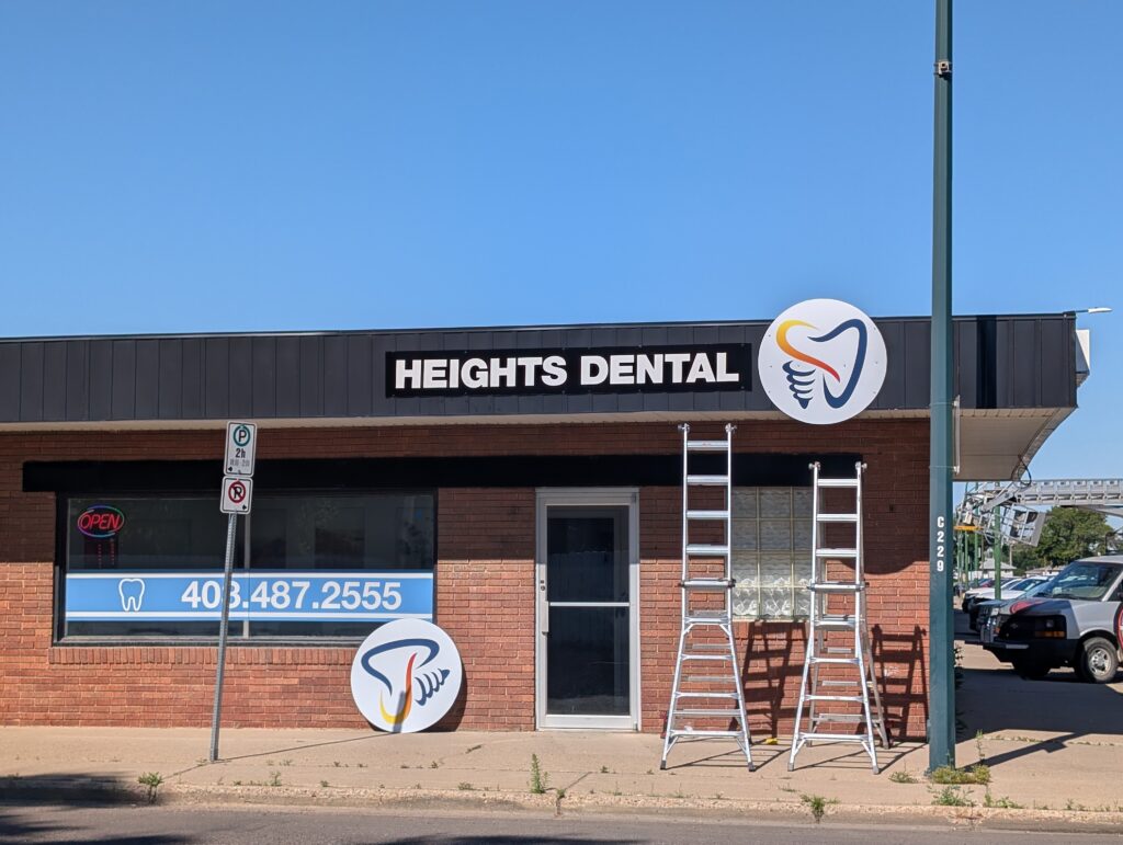 Commercial storefront signs installation at Heights Dental in Medicine Hat.