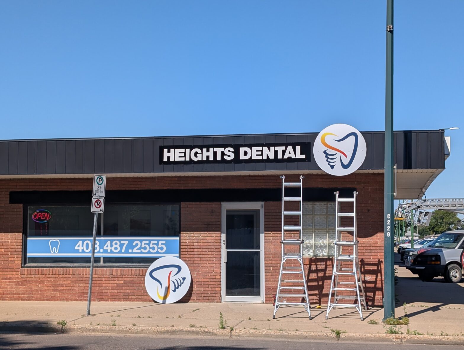 Exterior fascia sign and logo installation in progress for Heights Dental by SpeedPro Medicine Hat.