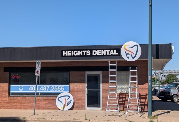 Exterior fascia sign and logo installation in progress for Heights Dental by SpeedPro Medicine Hat.